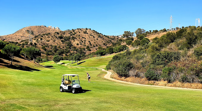 Playing golf on a sunny day at Cabopino Golf course, Spain