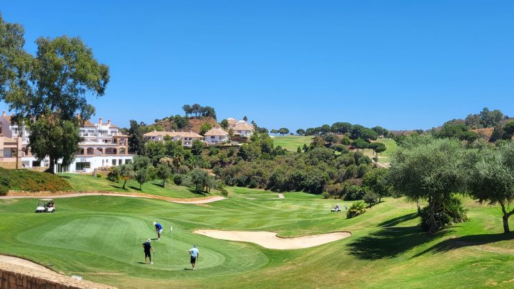 People playing golf on a sunny day on a green golf course from La Cala Golf Club Resort & Spa, Mijas Costa