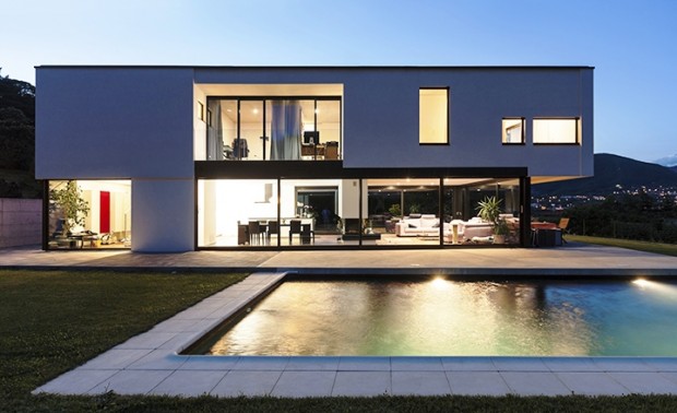 Night view of a luxury villa with pool and gardens in Marbella, Spain